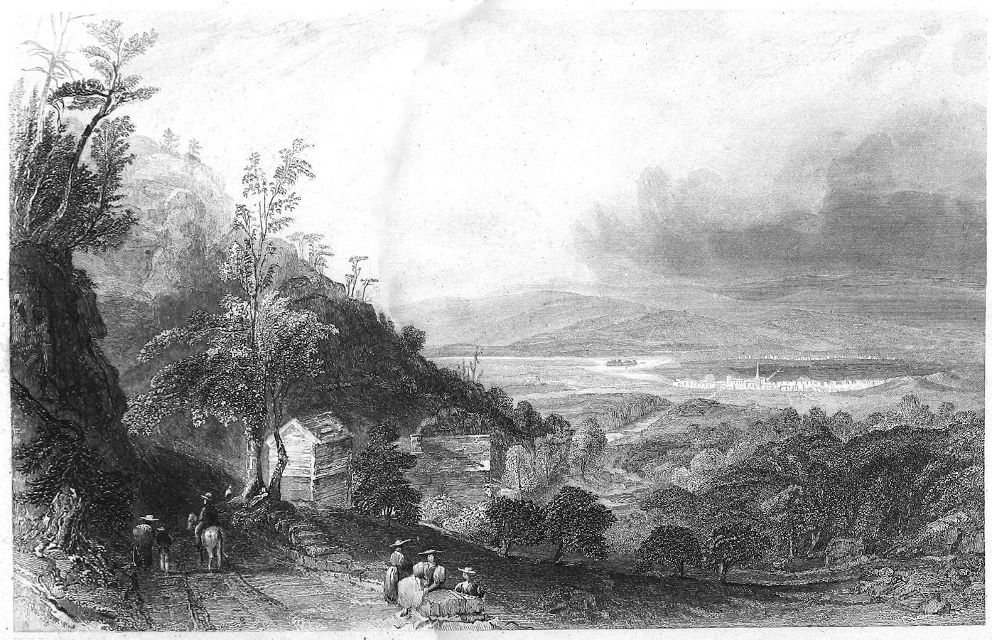 people on a hillside overlooking a valley