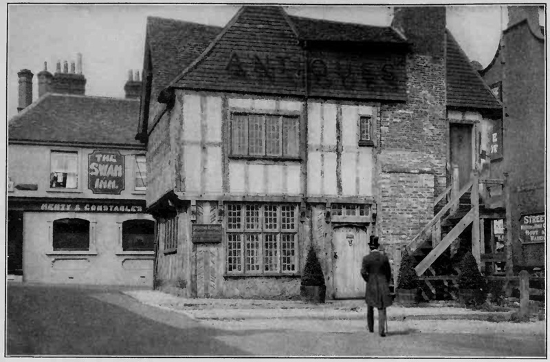 Man in tophat walks towards The Swan Inn