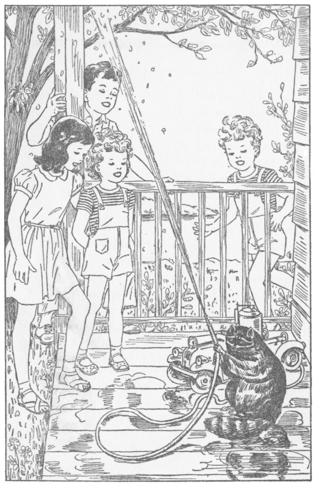 Four children are gathered on a porch watching a raccoon squirt water from a toy fire engine hose.