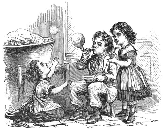 A boy and two girls are blowing bubbles