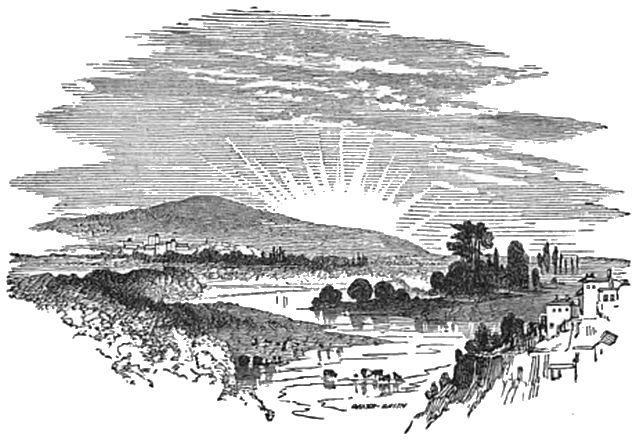 sun setting behind a hill