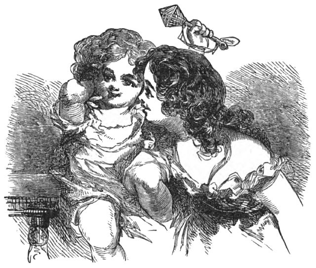 A woman is holding a child that is holding a rattle above their heads