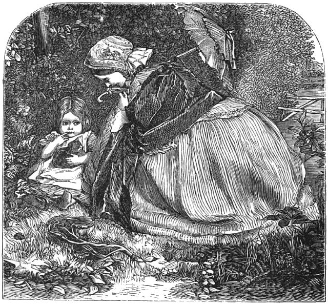 A woman with a parosal is sitting down next to a small girl who has a kitten in her lap.