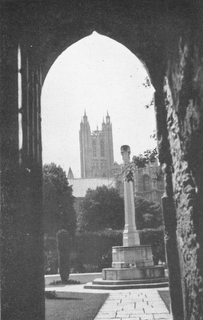 Canterbury bell tower seen in the distance through arch leading to Kent War Memorial