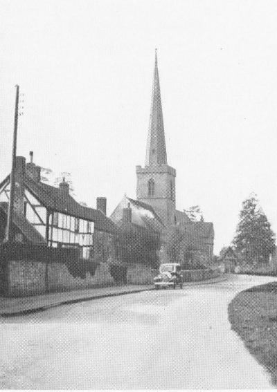 road with church with pointed spire on left