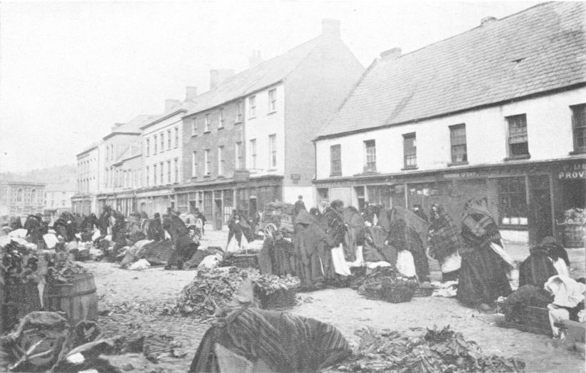 many people and their goods in a town square