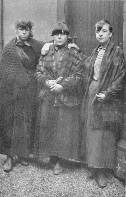 three young women wearing shawls
