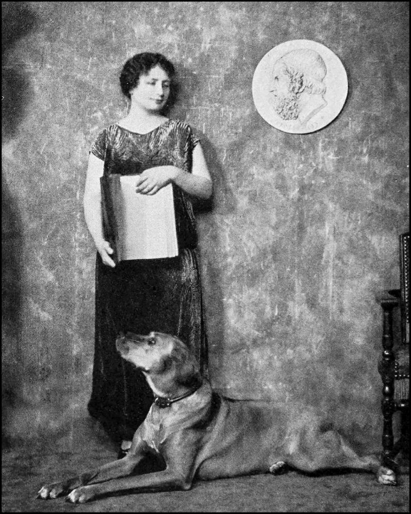 Woman standing and holding an open book. There is a dog laying down in the foreground and a large coin in the upper right corner.