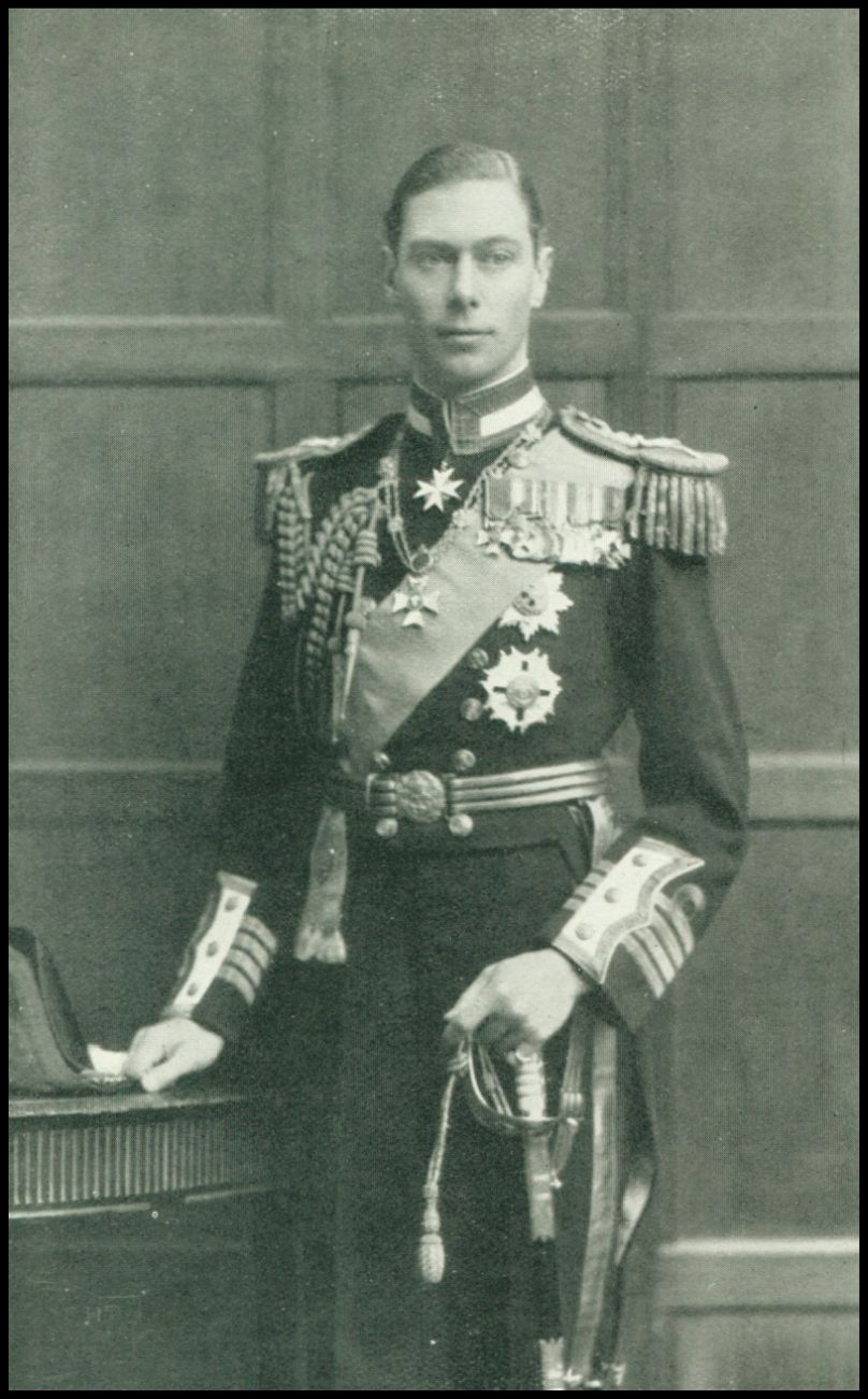 A man is standing and wearing a military uniform with a lot of medals on his chest.