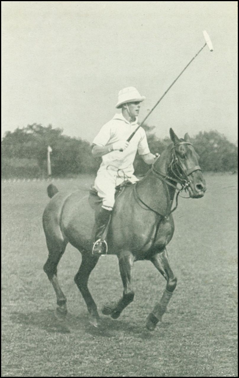 A man, dressed in whites and wearing a hat, is riding a horse and holding a polo mallet in his right hand.