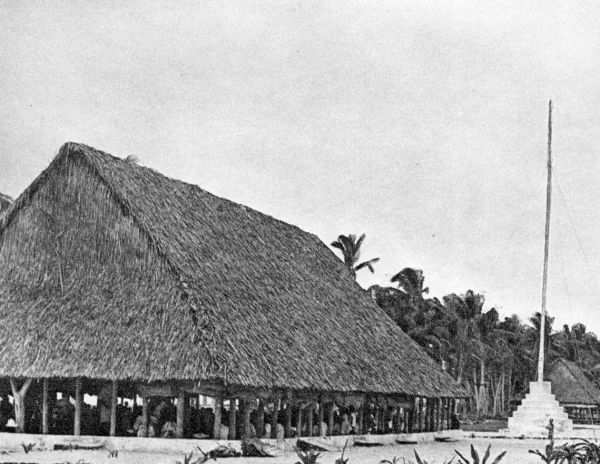 large open-air oblong-shaped building with packed foundation, coconut tree-poles supportin a palm-frond roof as high as the top of coconut palms