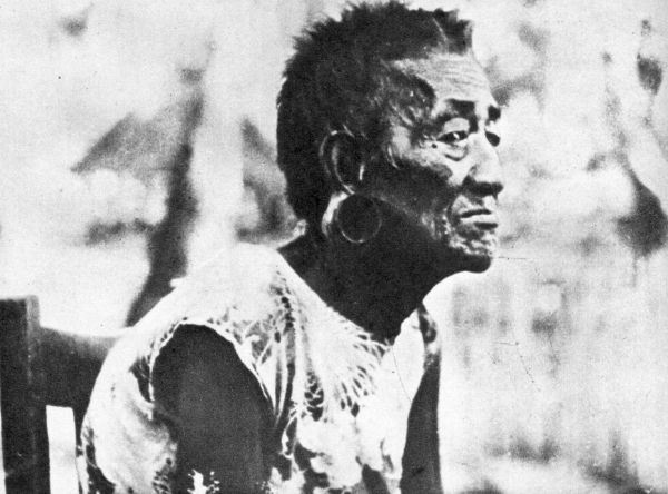 a side view of a very old woman with short hair and pierced ear