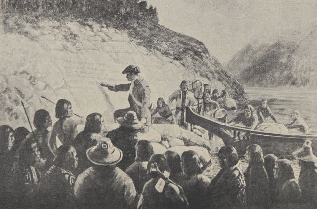 The painting shows a large group of people standing in the foreground. In the center of the painting is a man standing next to a large rock and he is etching into the rock. Another group of people is in the background standing next to a canoe at the riverbank. The majority of the people depicted appear to be Native Americans.