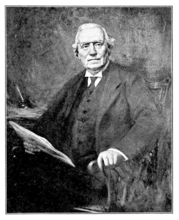 portrait picture of a white-haired man seated in 3 piece suit holding a document