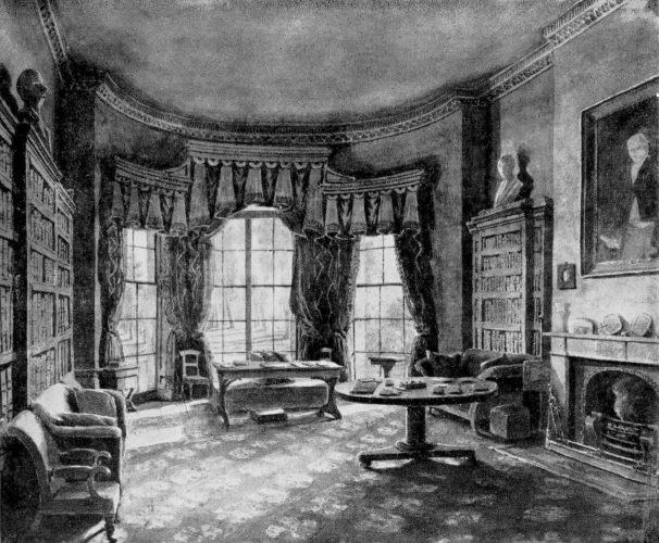 High-ceiling room with bookcases on two sides, glass windows at one end and fireplace along fourth wall