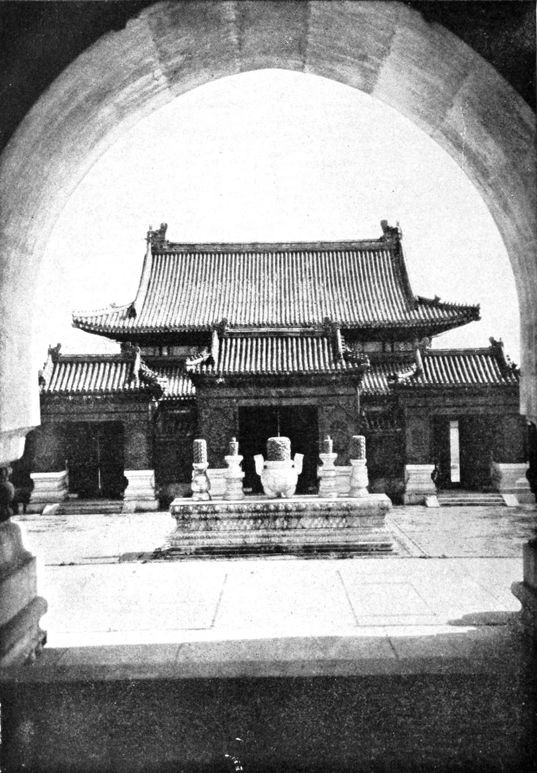 view of small building through an archway