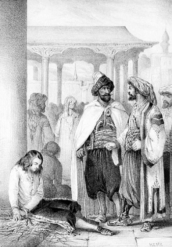 young man sitting with bound hands in an Arab market with two Arabs standing over him