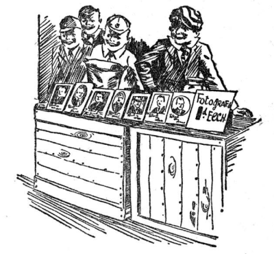 Four Outlaws grinning behind two wood crates with 7 male photos on top and a sign saying ‘Fotografs 1d eech’