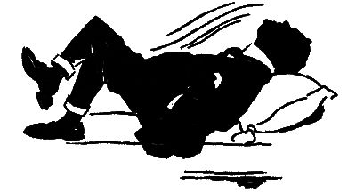 man in a suit lying down, head on a pillow, one leg crossed over the other