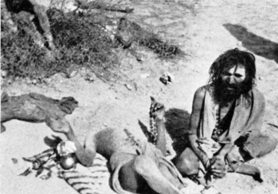 two men on the ground, one half-buried