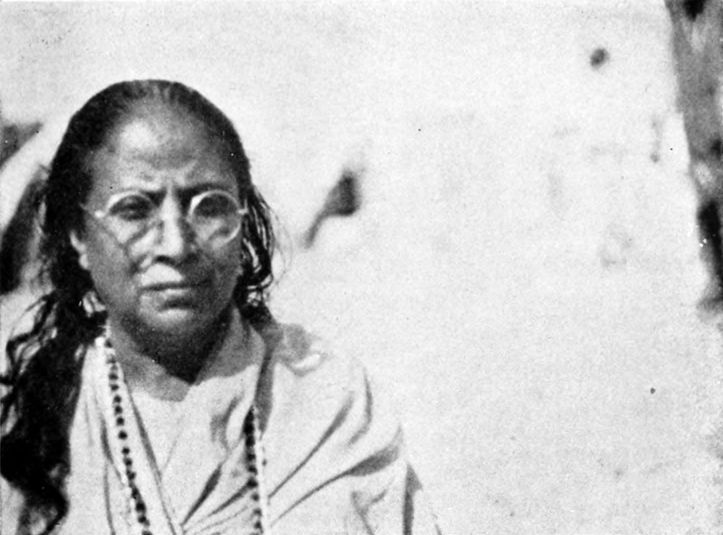 woman sitting before a wall