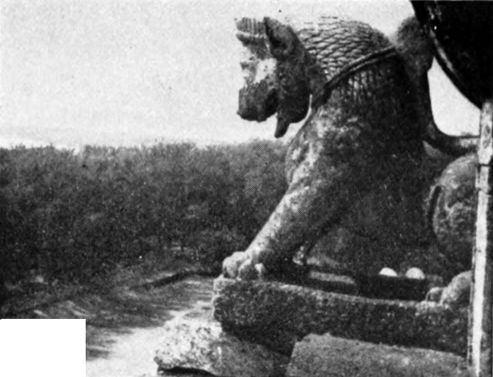 stone figure on side of building