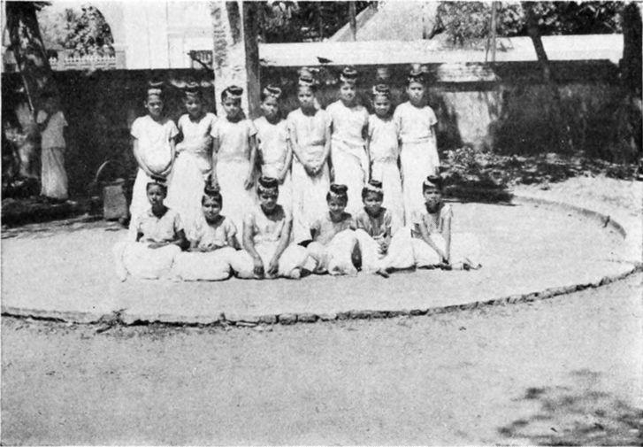 several young women wearing white garments