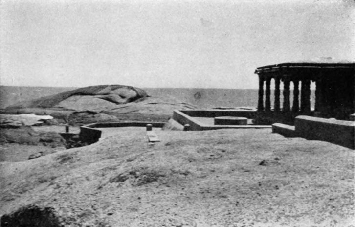 bare hills before a columned building