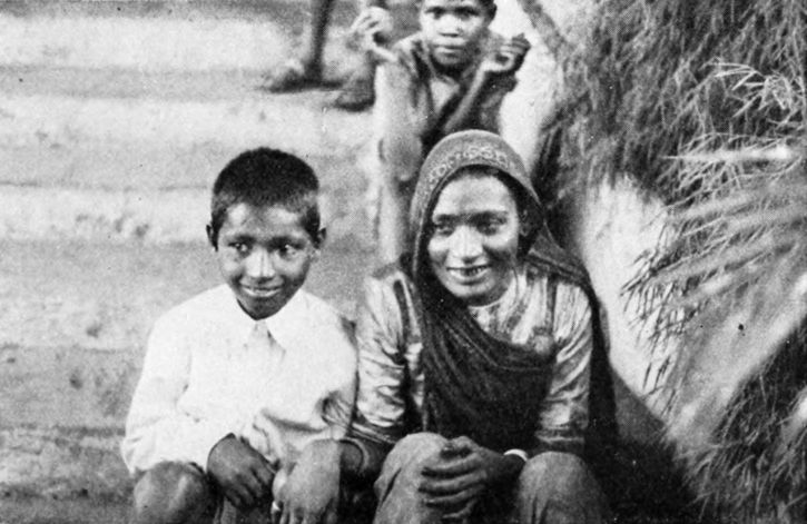 woman and boy sitting on stone steps