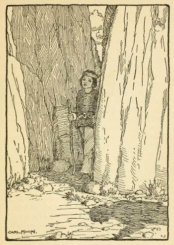 Indian boy standing in canyon tunnel listening to shadow