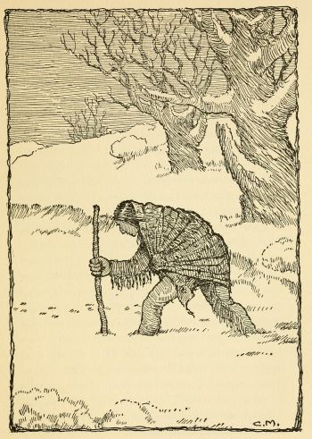 old Indian shrouded in a blanket walking through the snow with a walking stick