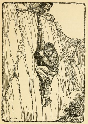 Indian boy climbing on a rope down the side of a cliff