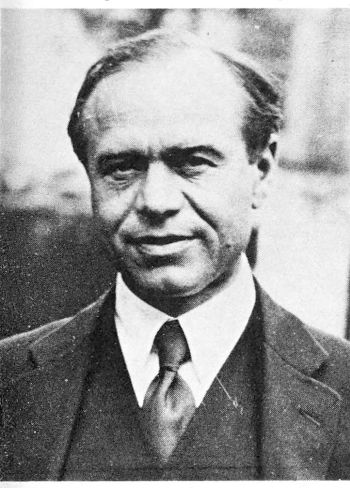 frontal photo of balding man in 3-piece suit