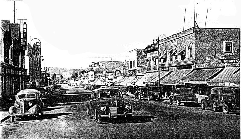 The Main Street of Penticton, with many stores with awnings and cars