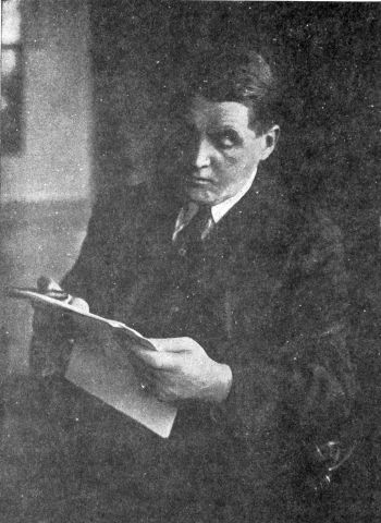 man in suit reading papers