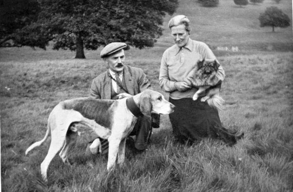 farmer and wife with old hound