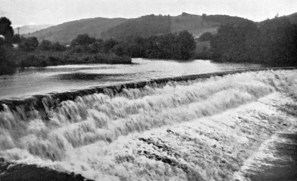 waterfalls at the edge of a lake