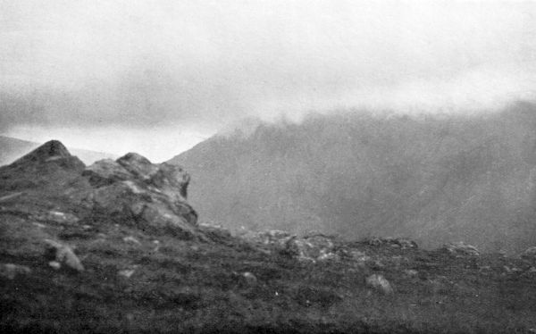 a rocky mountaintop with low hanging mist