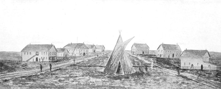 seven wooden buildings and a tepee