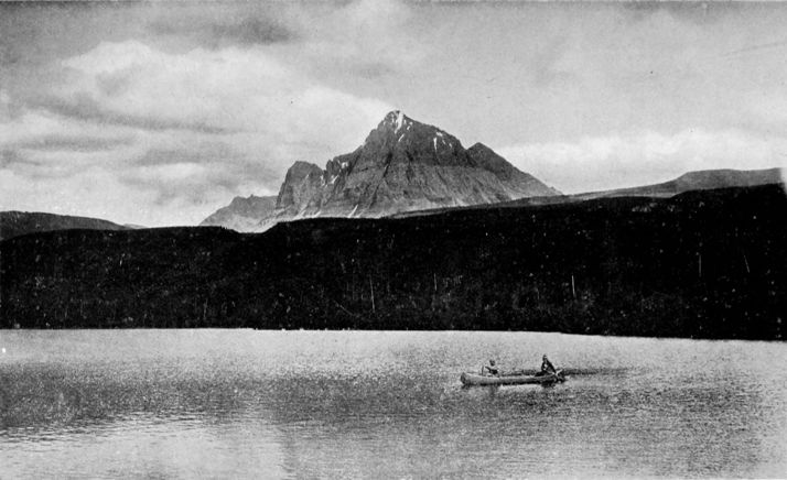 two men canoeing on a large mountain lake