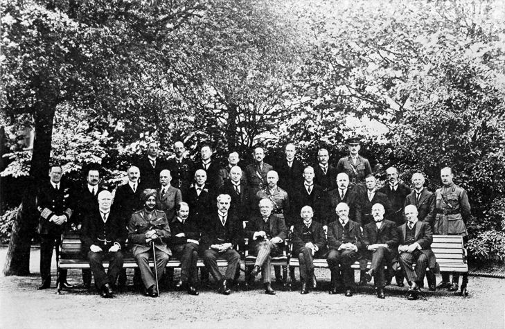 group photo of men wearing suits and uniforms