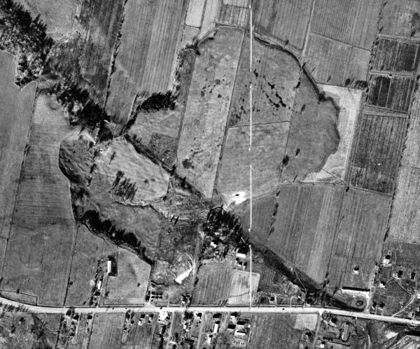 aerial view of farmland with landslide over fields and road