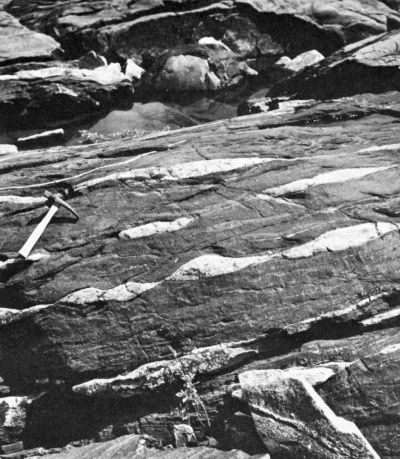 white twisted rock inside black rock slab