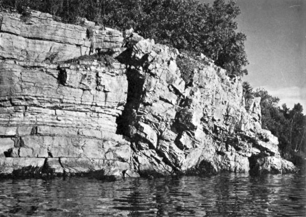 view from river of a limestone fault in riverbank