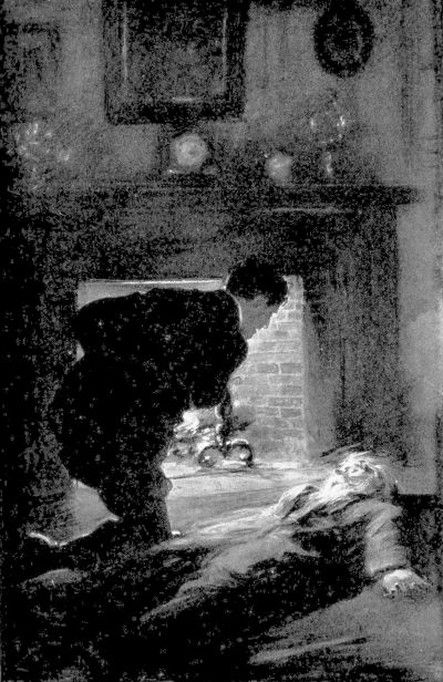 bearded man lying on his back in front of a fireplace with a man in a suit leaning over him