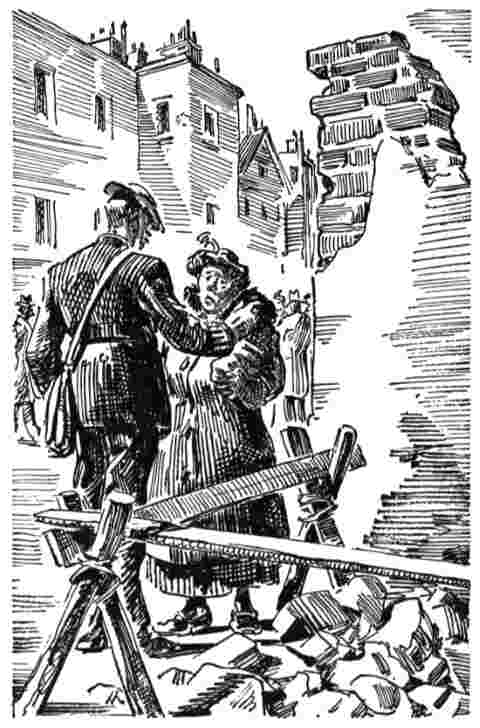 Soldier talks to woman amid ruined buildings