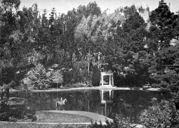 park ranger on horse on Lloyd Lake with portico on other side of lake