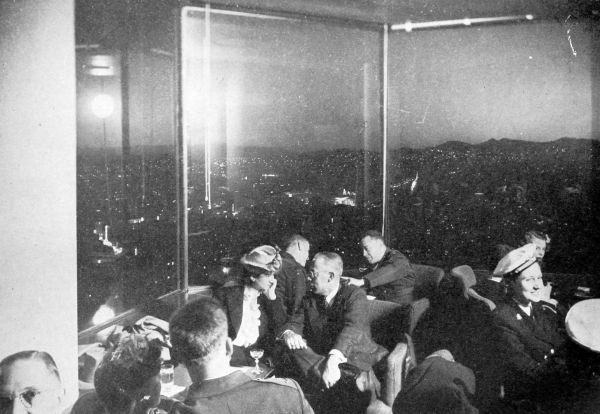 top floor cocktail lounge with glass wall night view of city
