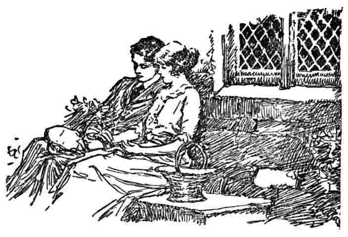 Man and woman sit on couch