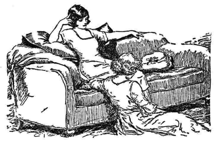 Woman sits at feet of another woman